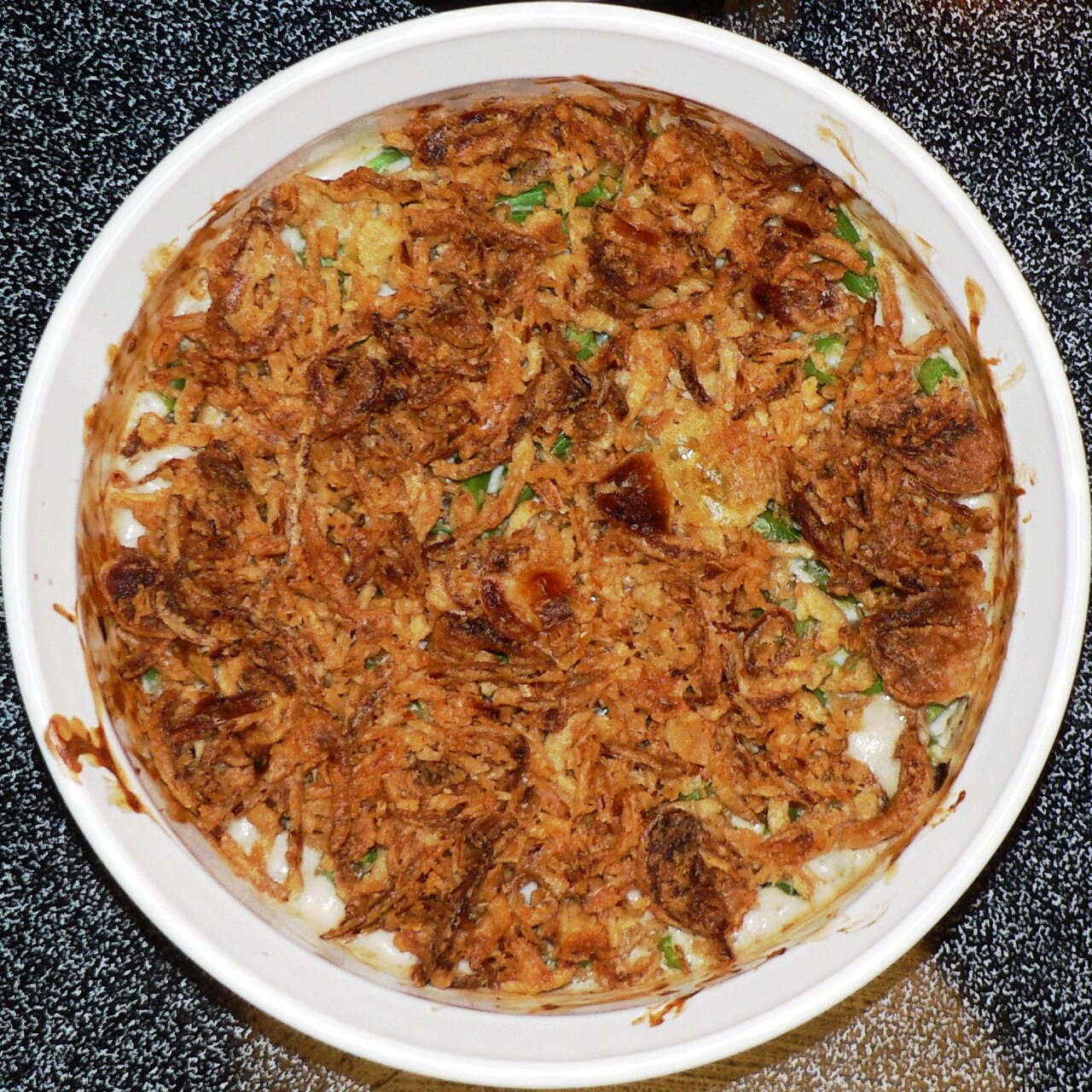 Green bean casserole topped with browned fried onions