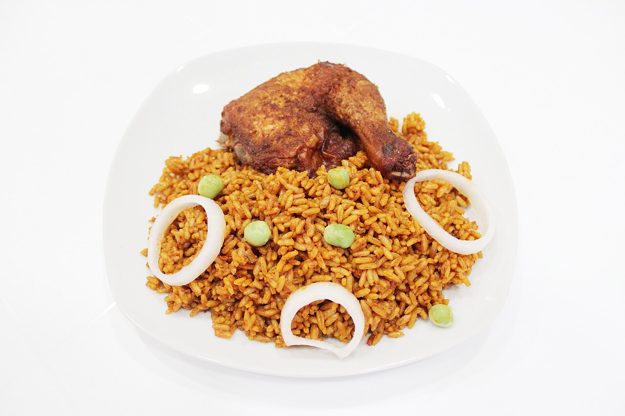 Nigerian jollof rice served with chicken and garnishes