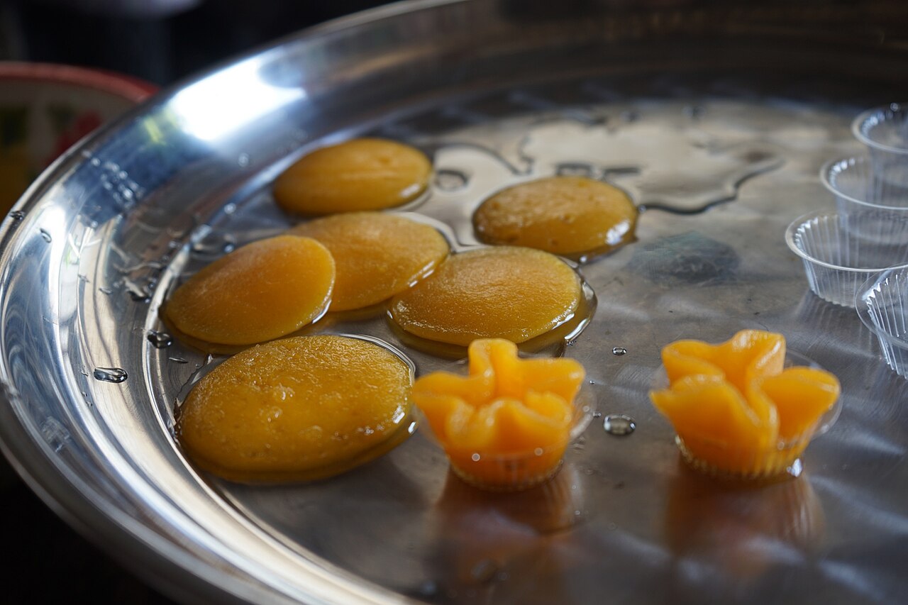 Golden thong yib egg-yolk sweets arranged in syrup
